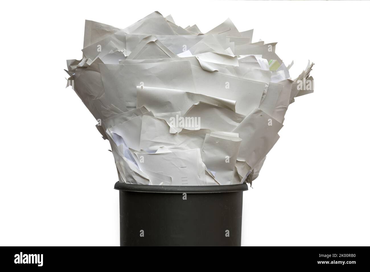 Full trash against a white background as a symbol of paper usage and costs Stock Photo