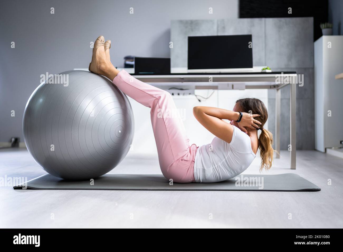 Exercise Workout With Fitness Ball At Office Desk Stock Photo Alamy