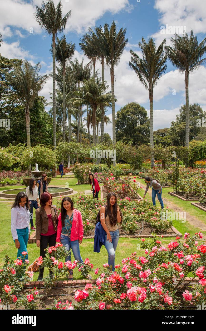 Colombia,Bogota, The botanical garden, Jardin Botanico. Colombian girls visit the rose garden with the wax palms behind them Stock Photo