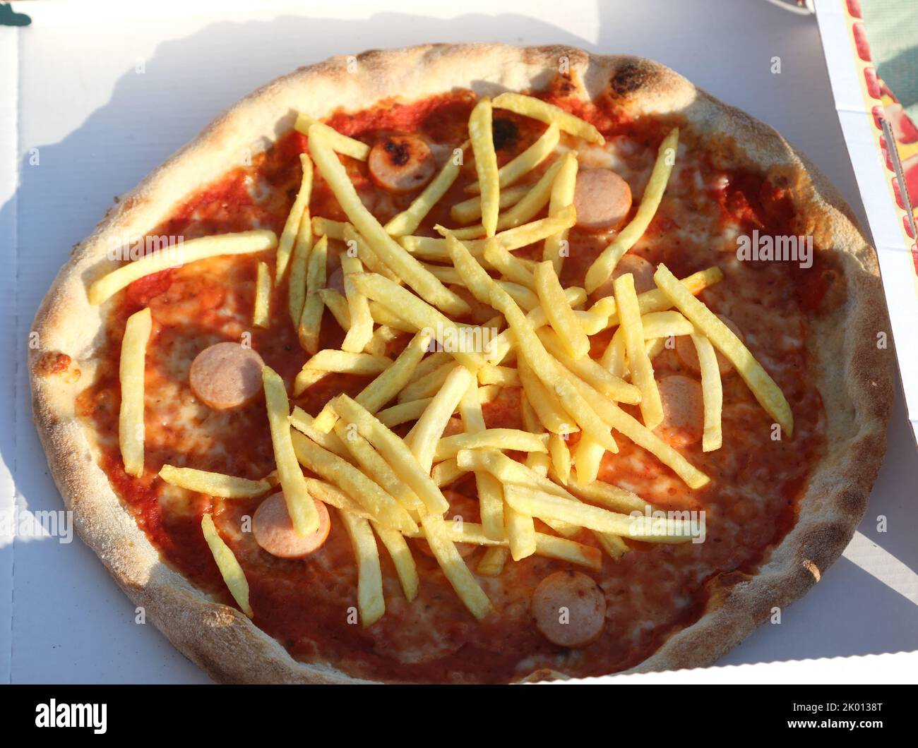 pizza with french fries and wurstel mozzarella cheese and tomato sauce