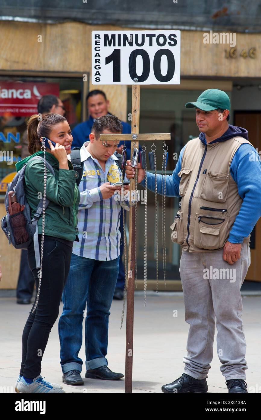 Colombia, Bogota,a man is renting out several mobile phones to passers