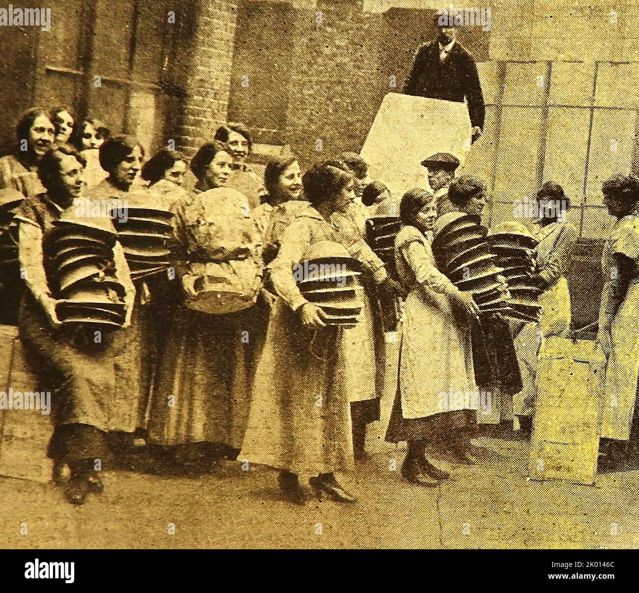 WWI - Munition workers at a a steel helmet factory making ready to pack  supplies Stock Photo