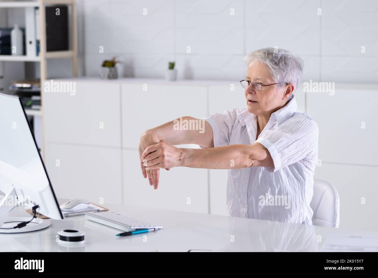 Office Worker Stretching And Relaxed Behind PC Stock Photo Alamy