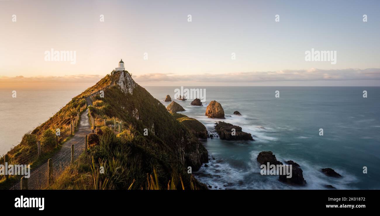 Sunrise over Nugget point lighthouse, Southland. Stock Photo