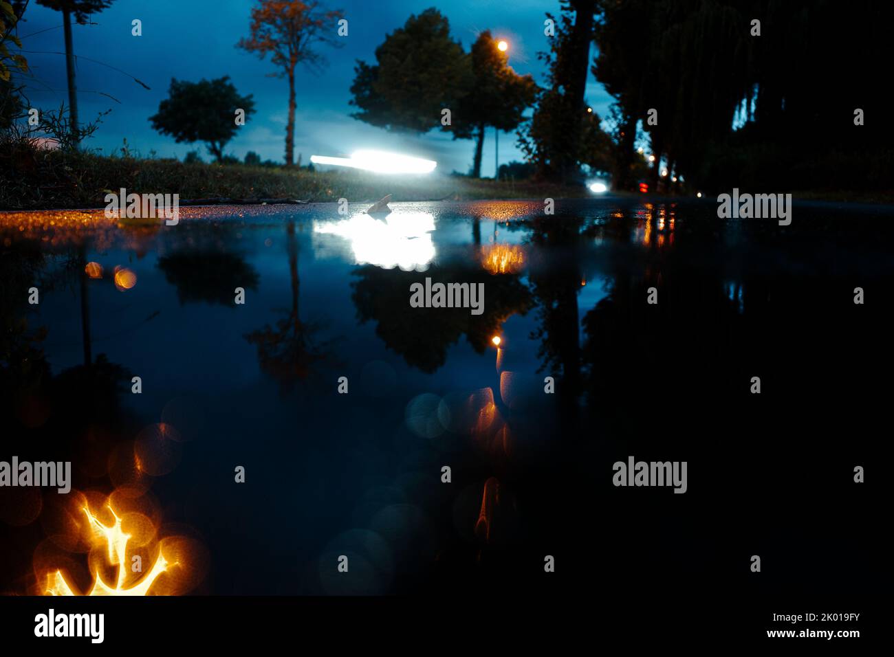 abstract and blurry view of stormy night at roadside with car