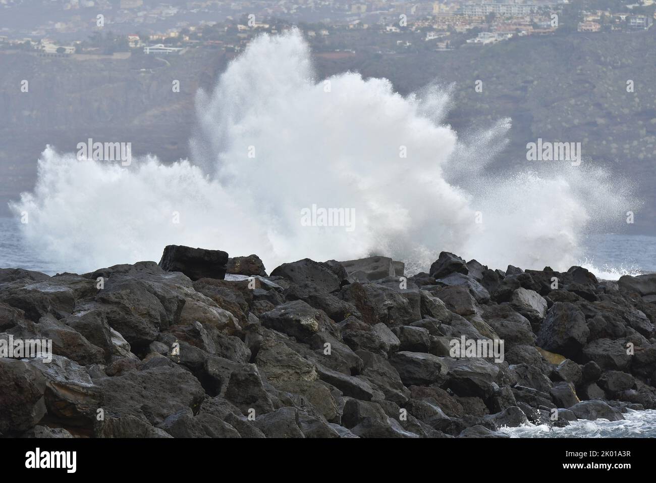 Waves crashing on volcanic rocks near Puerto de la Cruz on the northern coast of Tenerife Canary Islands Spain. Stock Photo