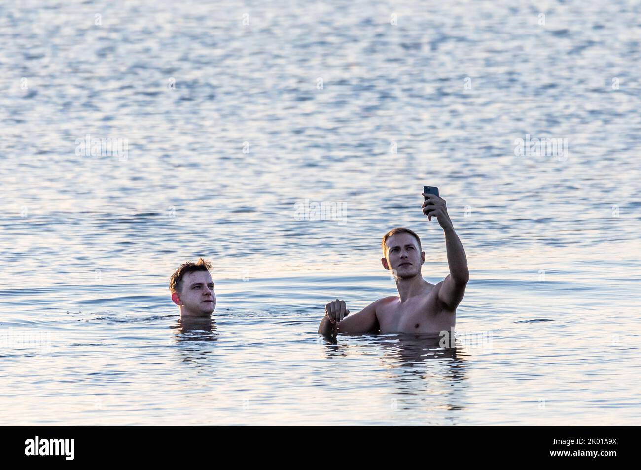 Loughbeg, Cork, Ireland. 09th September 2022. Brothers Harry and Conor Kiy make selfies during their morning swim at Loughbeg, Ringaskiddy, Co. Cork., Ireland. - Credit; David Creedon / Alamy Live News Stock Photo