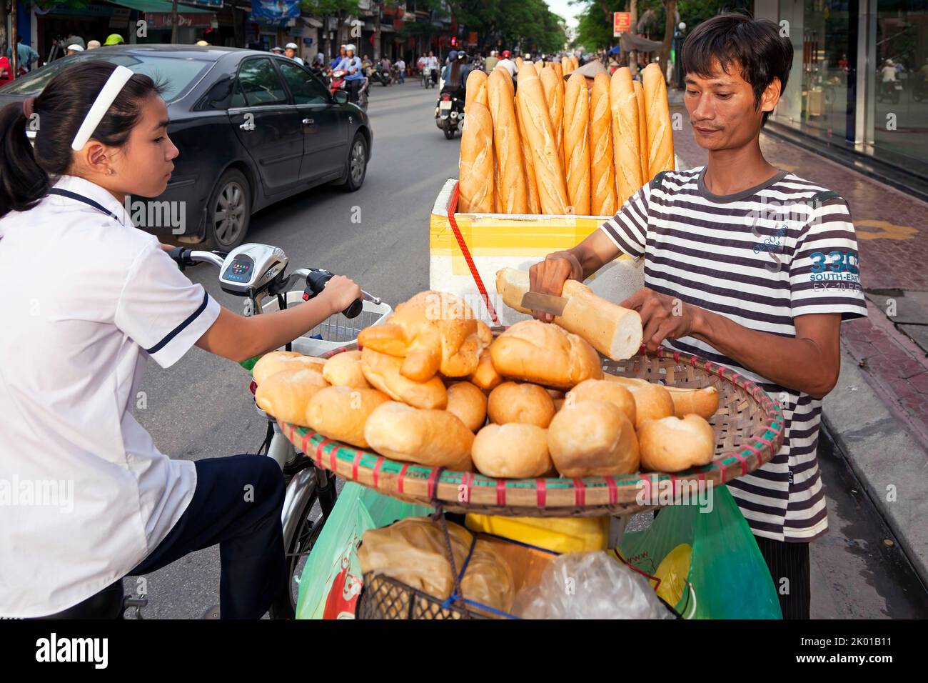 Vietnamese man selling french bread in the street, Hai Phong, Vietnam Stock Photo