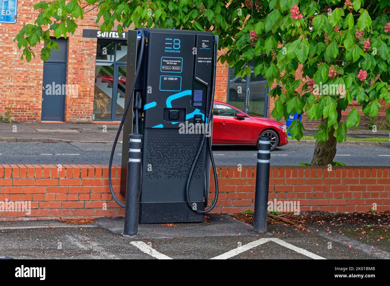 modern hi tech electric car charging point in car park, lancashire,england,uk Stock Photo