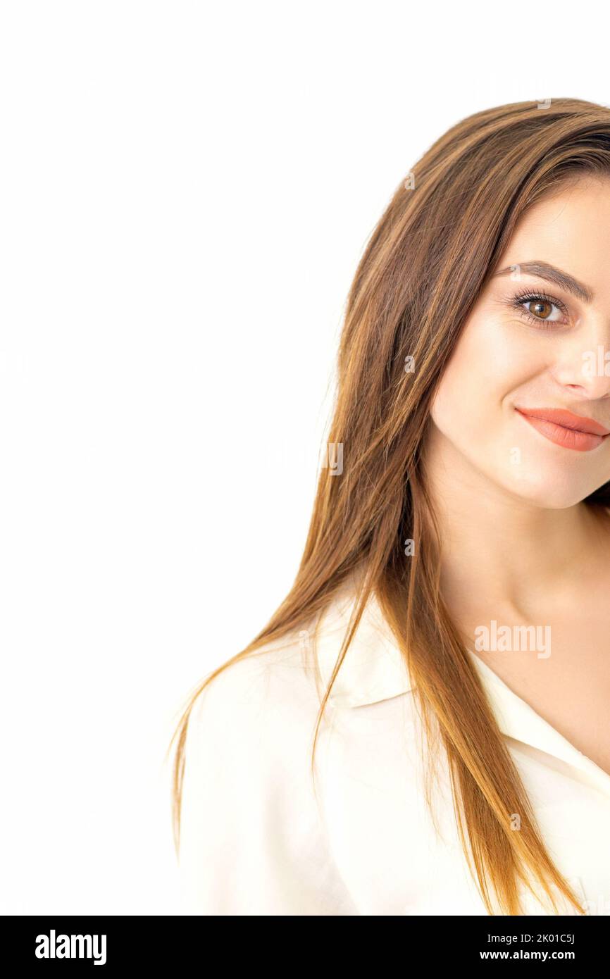 Portrait of a beautiful young caucasian smiling brunette woman with long straight hair standing and looking at the camera on white background Stock Photo