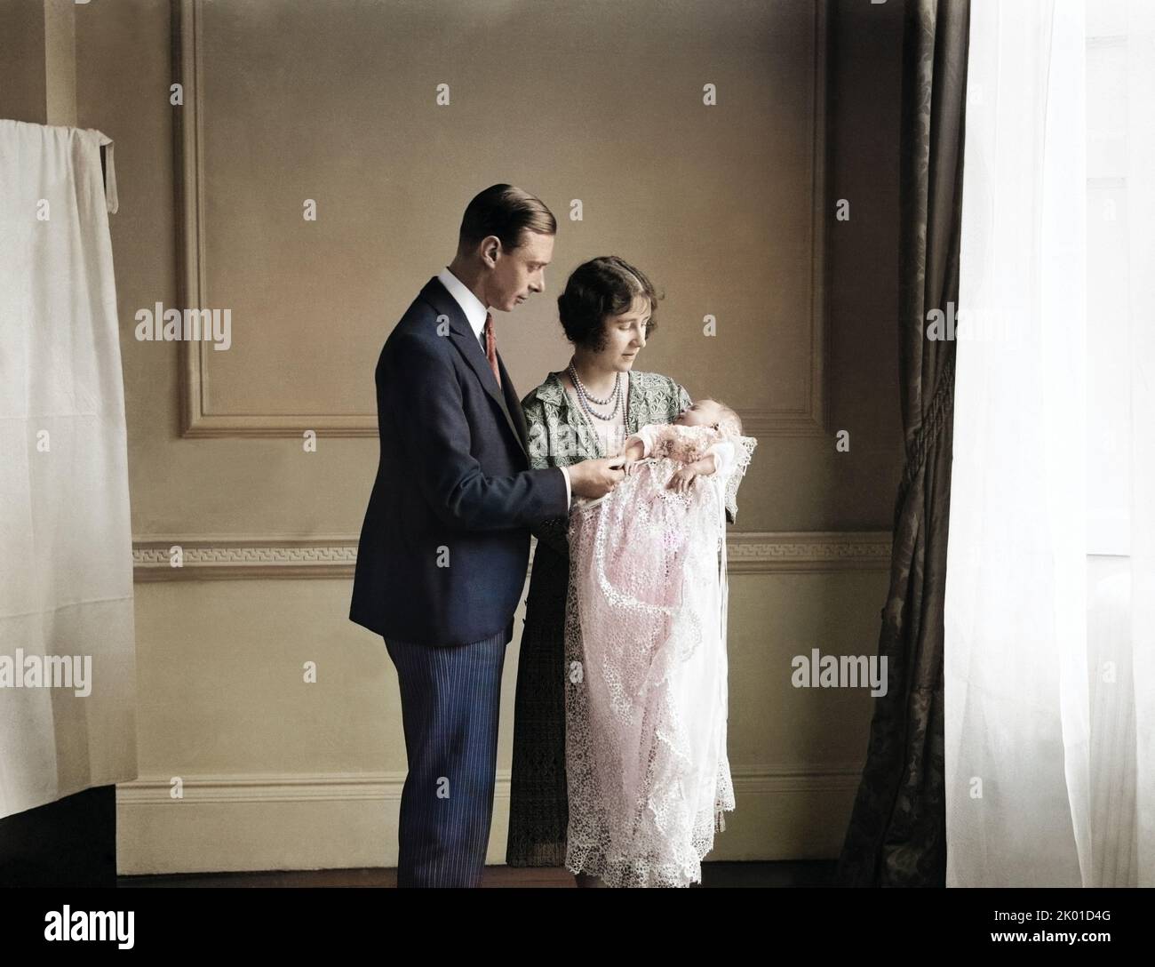 The Queen Mother (then the Duchess of York) with her husband, King George VI (then the Duke of York), and their daughter Queen Elizabeth II at her christening in May 1926 - colorized Stock Photo