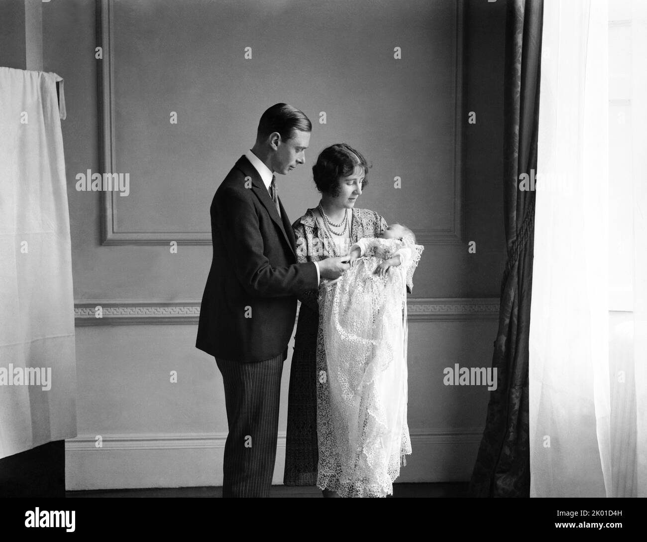 The Queen Mother (then the Duchess of York) with her husband, King George VI (then the Duke of York), and their daughter Queen Elizabeth II at her christening in May 1926 Stock Photo