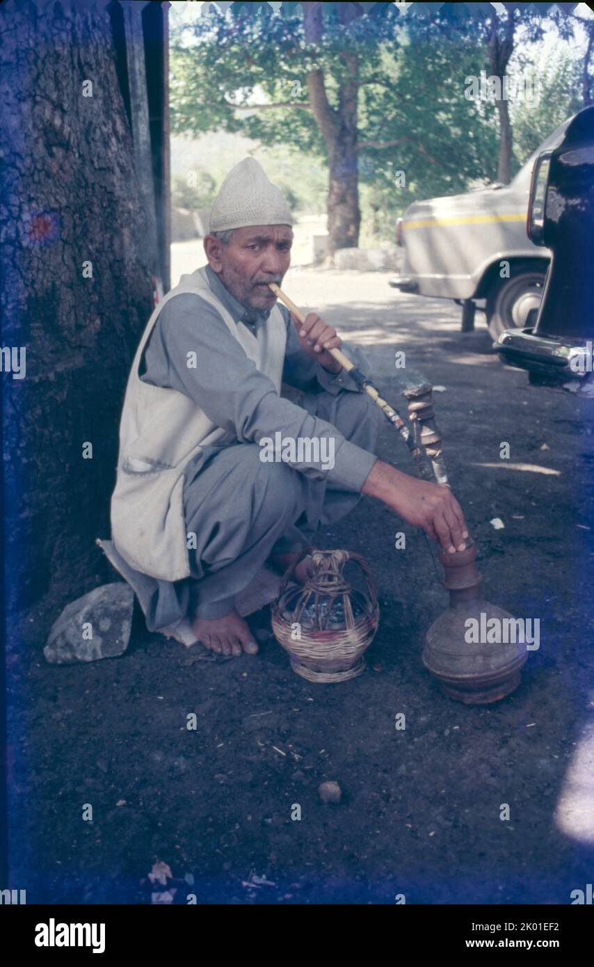 Old Man Drinking Hukka Sri Nagar, Kashmir Stock Photo