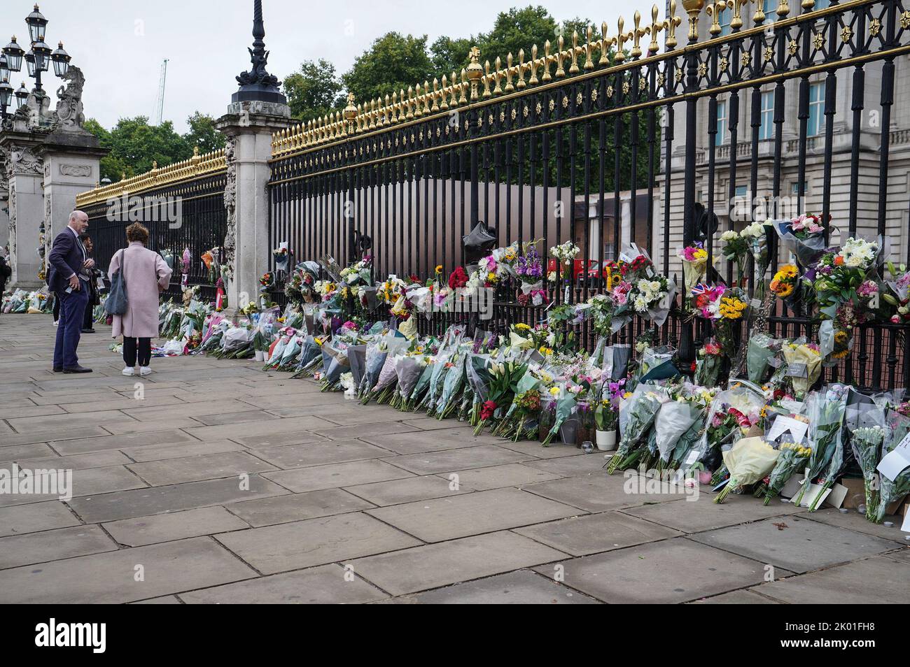 Flowers are laid at the Palace gates as mourners pay their respects