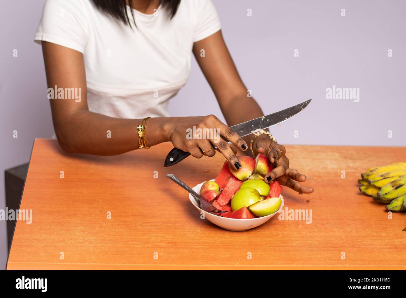 african woman cutting up some fruits Stock Photo Alamy