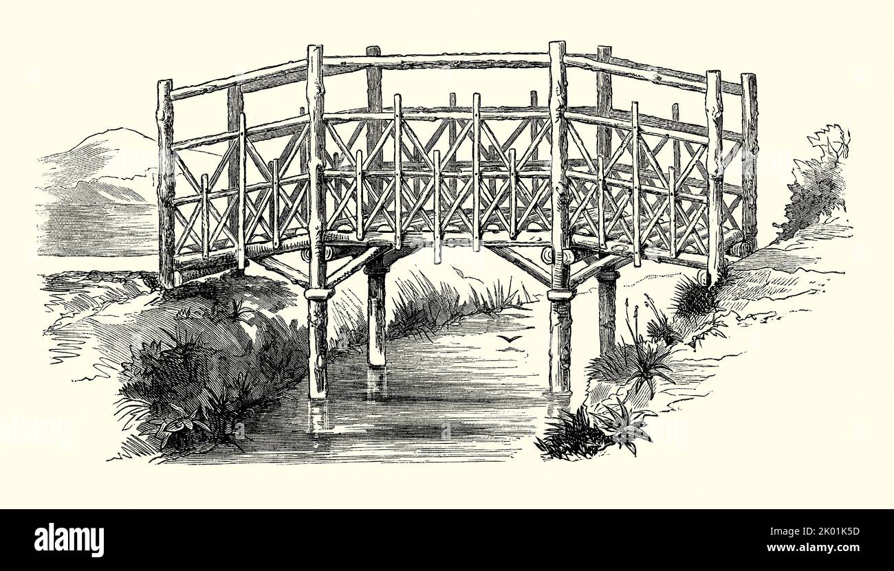 An old Victorian engraving of a design for a rustic, timber, garden footbridge. It is from a book of 1890. Here the bridge spans a waterway, stream or pond in the garden. Stock Photo