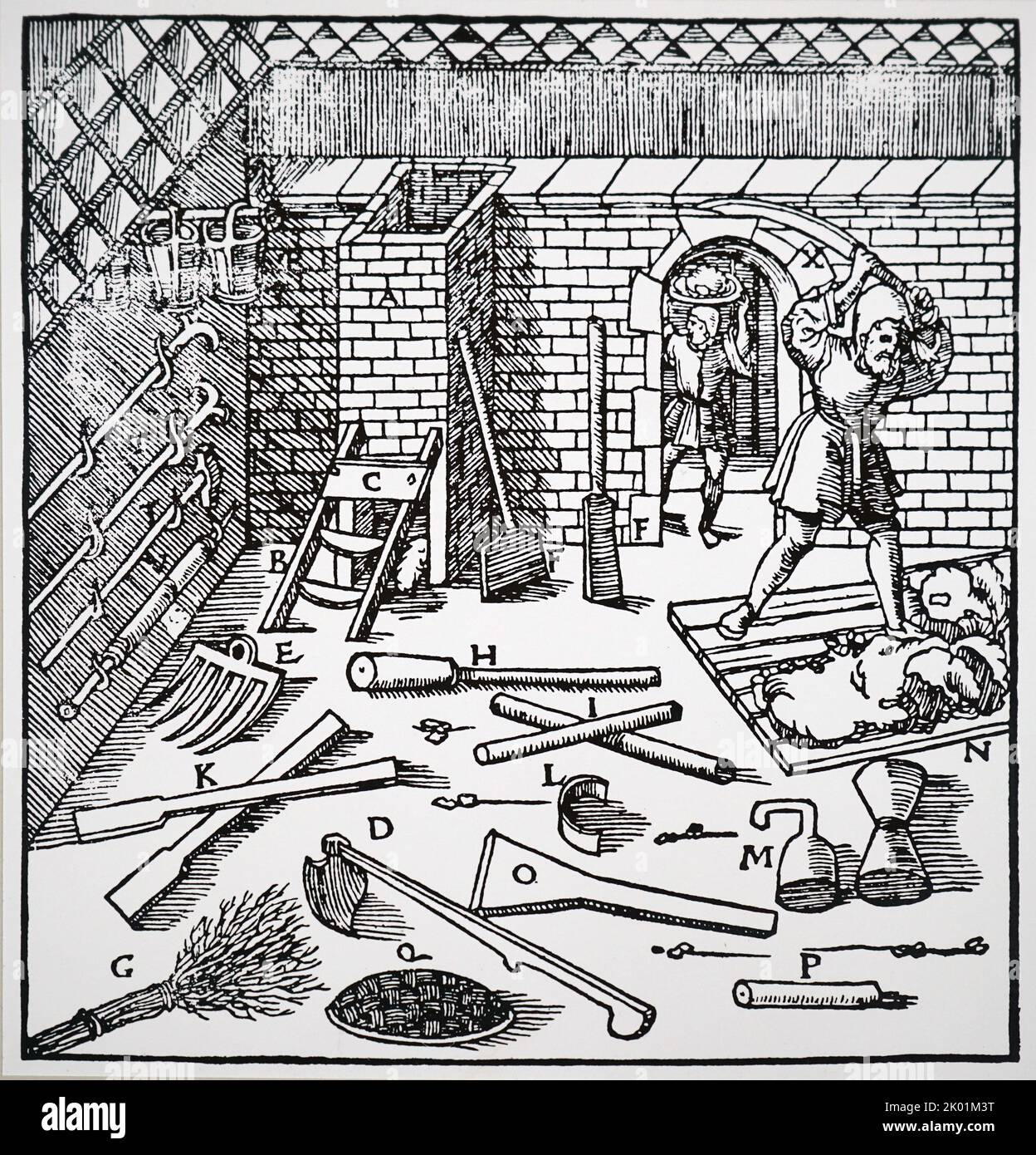 The smelting of ores, gold, silver, copper or lead. Workman beating clay to make lute with which to line furnace before smelting. Basle, 1556. Stock Photo