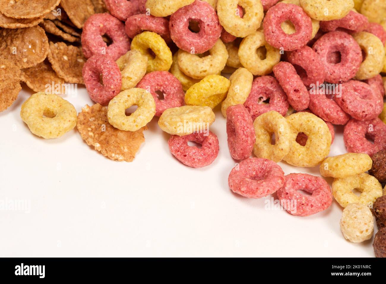 Cereals from corn in the form of multicolored rings on a white background Stock Photo Alamy