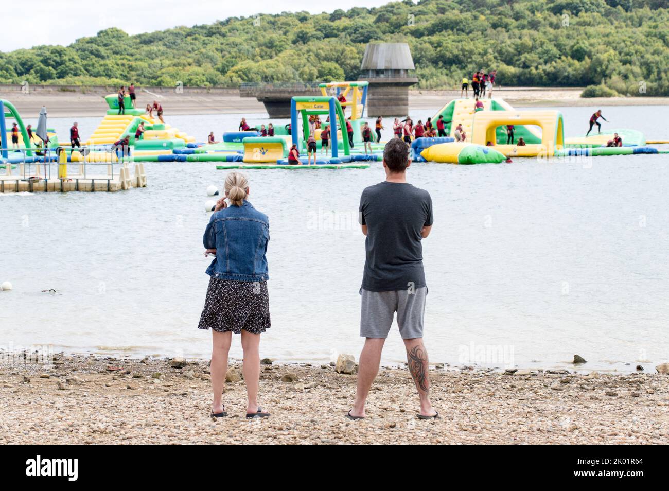 Spectators watching the Aqua park from the shore at Bewl water Stock Photo
