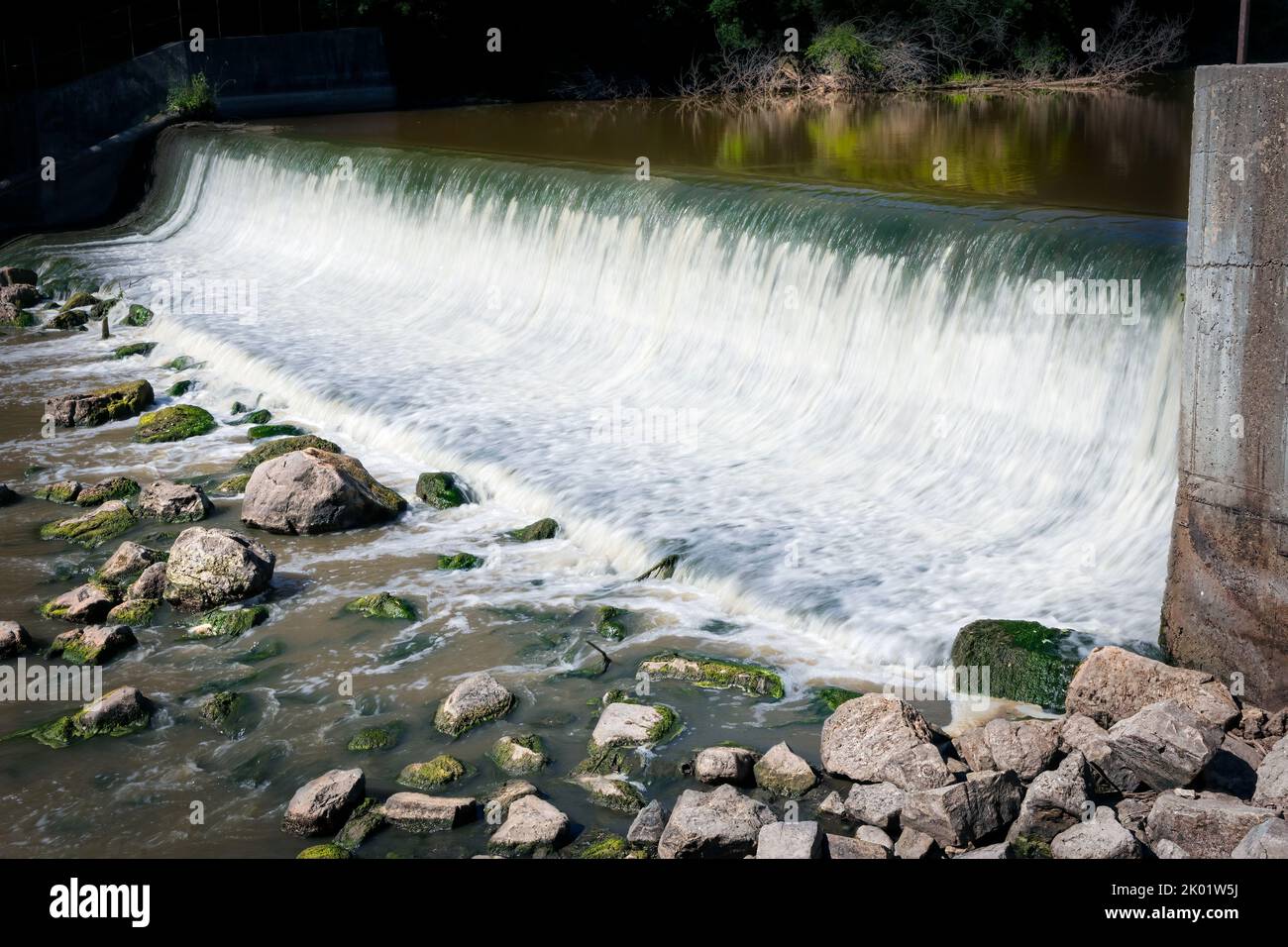 The Manitowoc River flows over the dam near the little town of Clarks Mill near Manitowoc, Wisconsin. Stock Photo