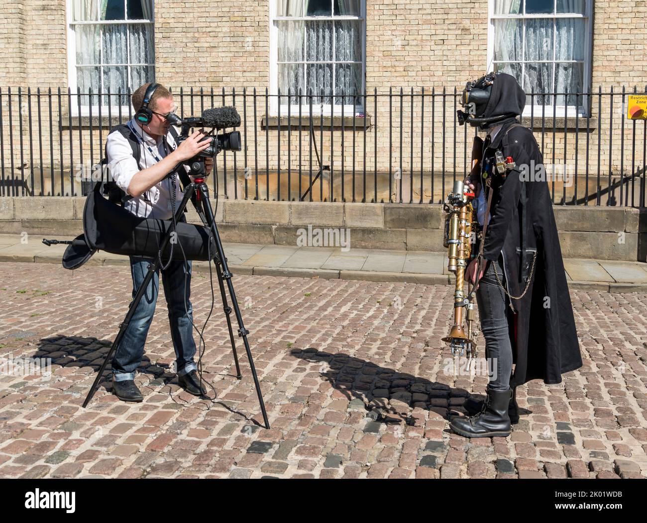 Steampunk dressed person being videoed for local television, Castle Hill Lincoln 2022 Stock Photo