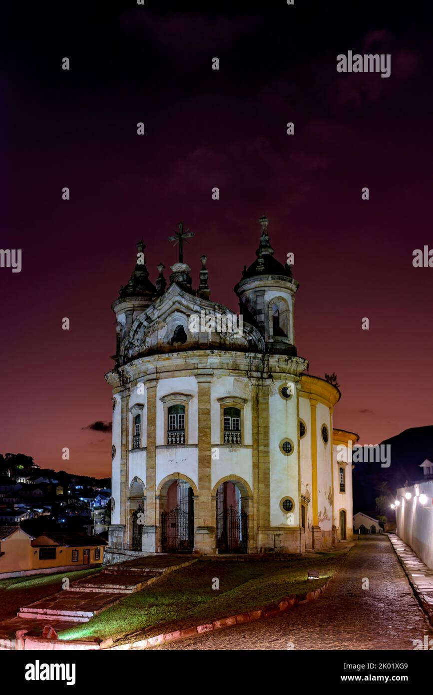 Old baroque church illuminated at dusk in the historic town of Ouro Preto in Minas Gerais Stock Photo