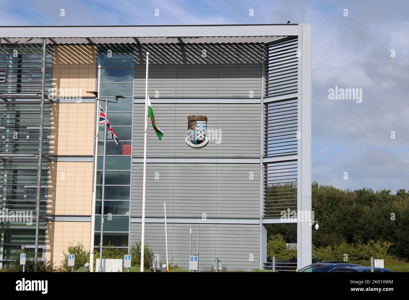 Canolfan Rheidol Ceredigion council office building flying flags at half mast following the passing of Her Majesty Queen Elizabeth II Stock Photo