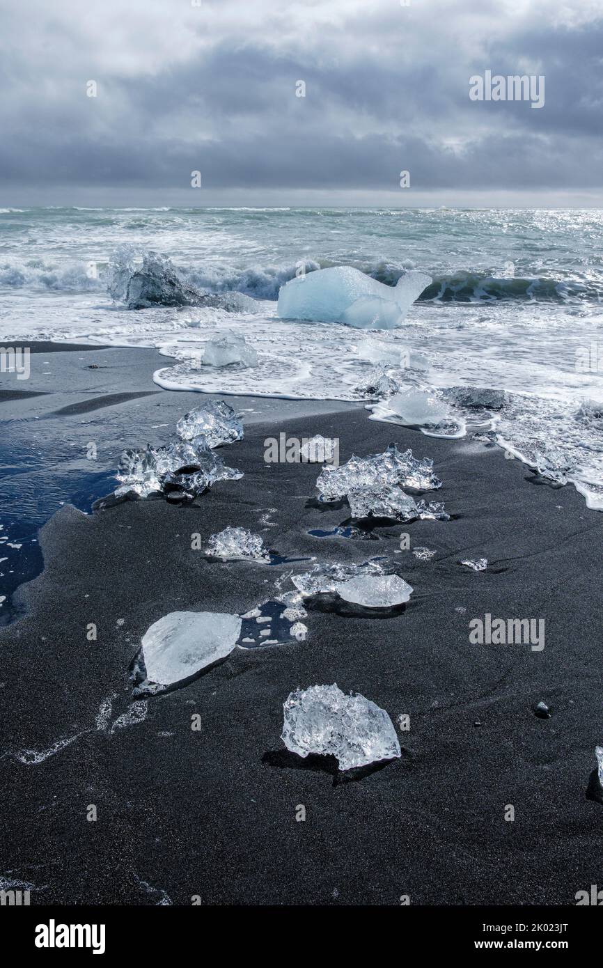 Blocks of ice from the Jokulsarlon glacial lagoon washed up on Diamond Beach, Iceland Stock Photo