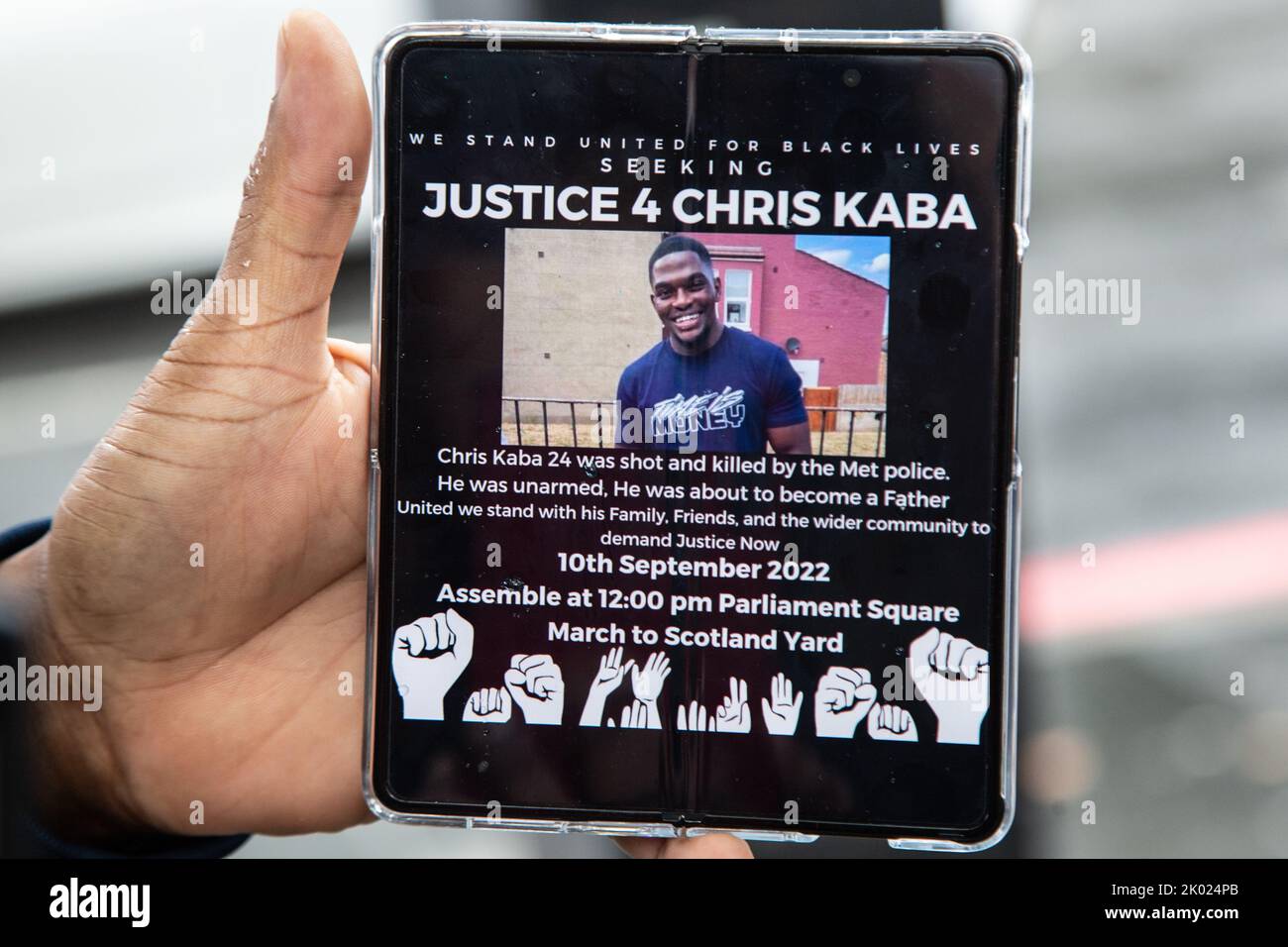 London, UK, 9th Sep 2022 London UK A Man shows protestters a digital flyer for a planed  demonstration for Chris Kaba whot was shot dead by police.  Chris Kaba, 24, was shot dead by an armed Met Police unit following a car chase in Streatham, south London. An investigation by the Independent Office for Police Conduct found out that he was not armed. Stock Photo
