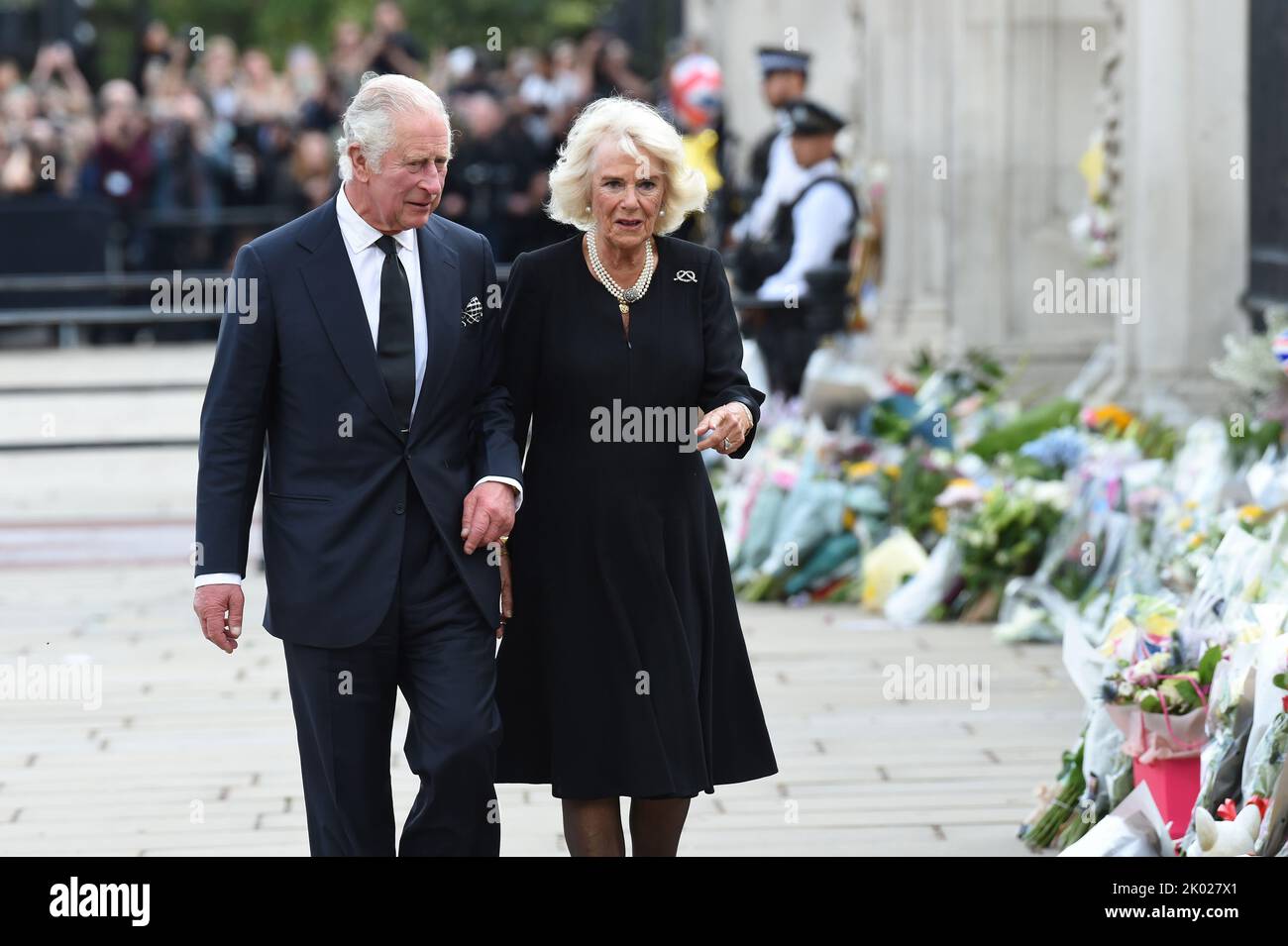London, UK. 9th Sep, 2022. King Charles lll and the Queen Consort walk outside of Buckingham Palace to view the floral tributes left for his late mother Queen Elizabeth ll who died yesterday and to meet the large assembled crowd of well wishers and mourners. Credit: MARTIN DALTON/Alamy Live News Stock Photo
