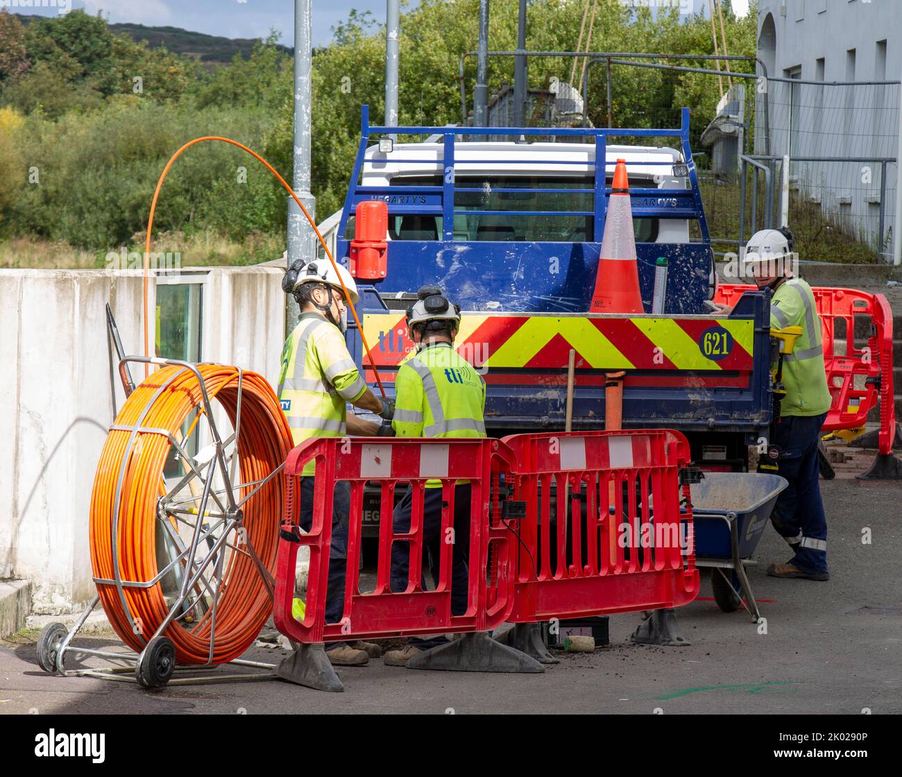 Engineers installing fibre optic cable underground Stock Photo