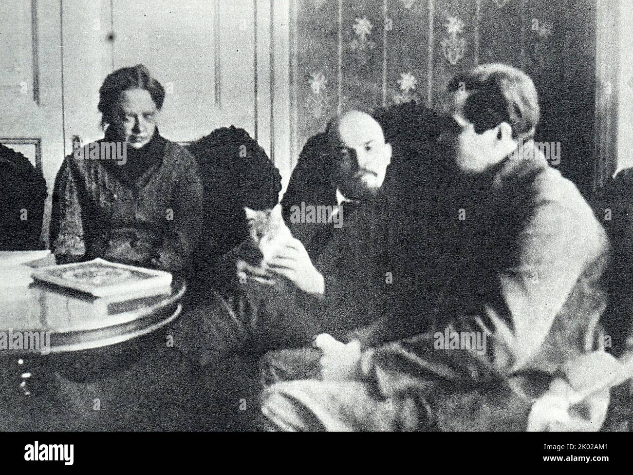 Vladimir Lenin with Krupskaya, , in their Kremlin apartment talking with American correspondent Lincoln Eyre. February 1920, Moscow. Photographer - W. Cubes (American). Stock Photo