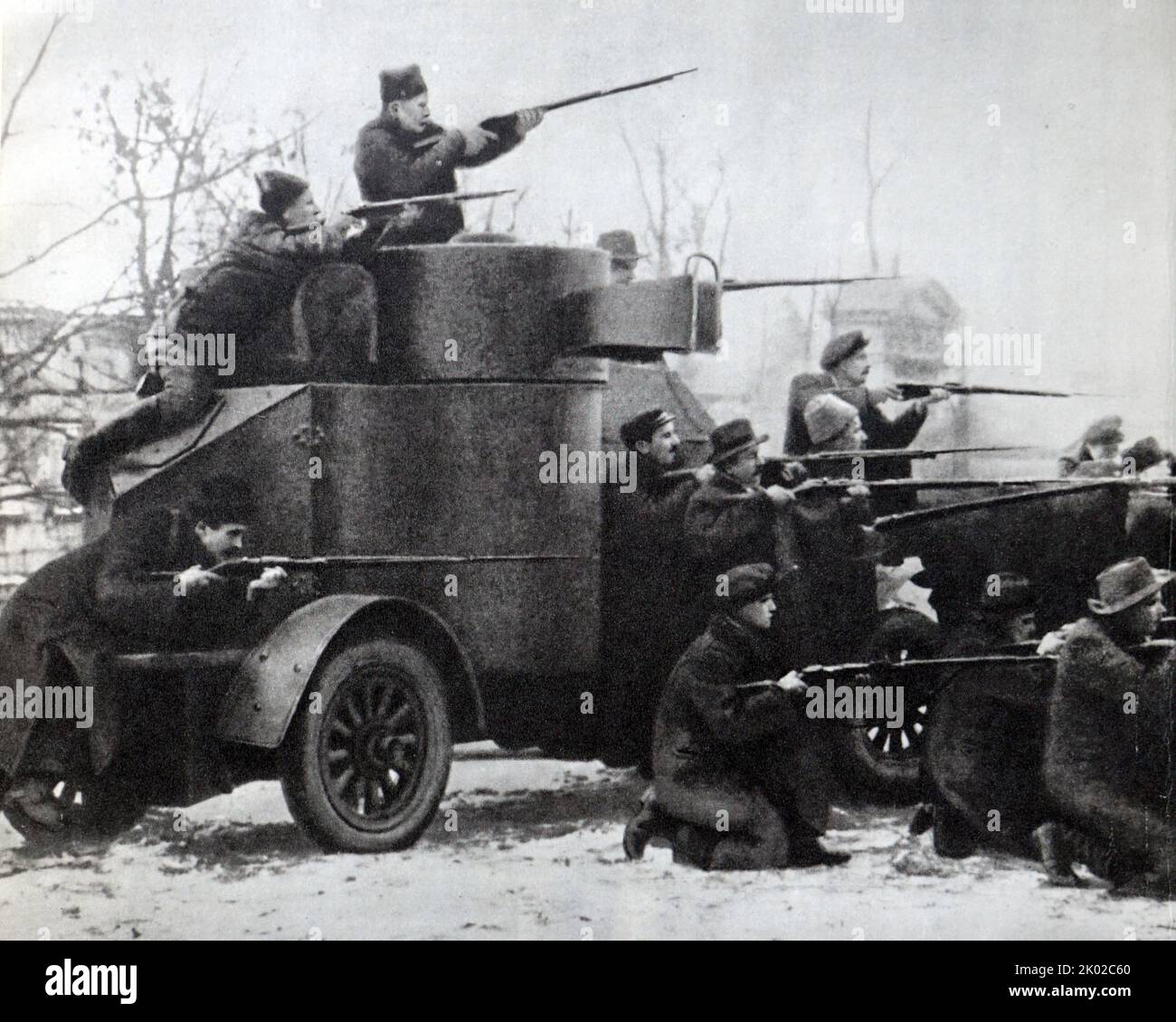 Red Guards with an armoured car captured from the cadets on the night of October 25, 1917. Photo by P. Otsup. Stock Photo