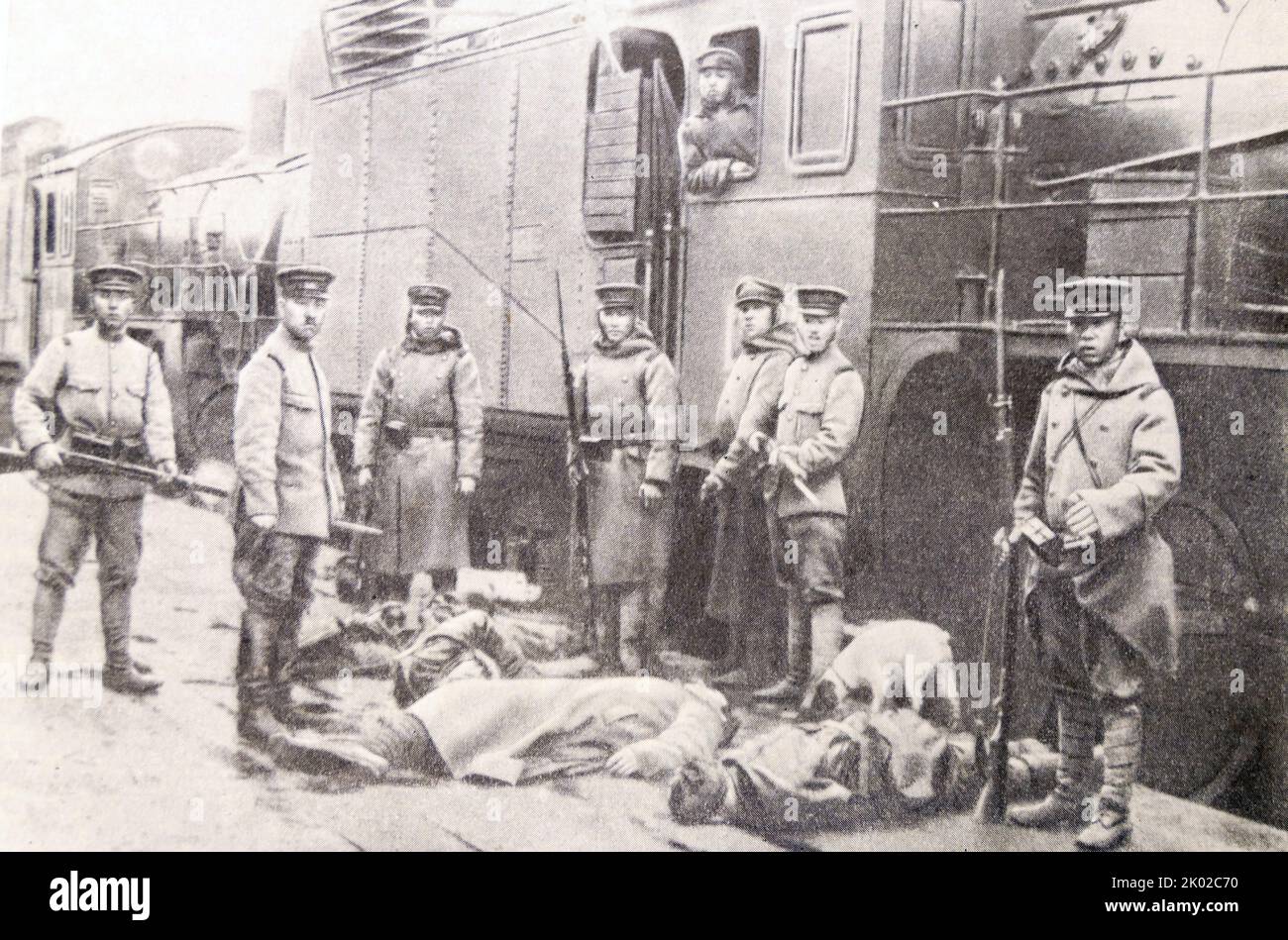 Japanese interventionists standing behind bodies of railway workers executed by them. Far East of Russia. Russian Civil War Stock Photo