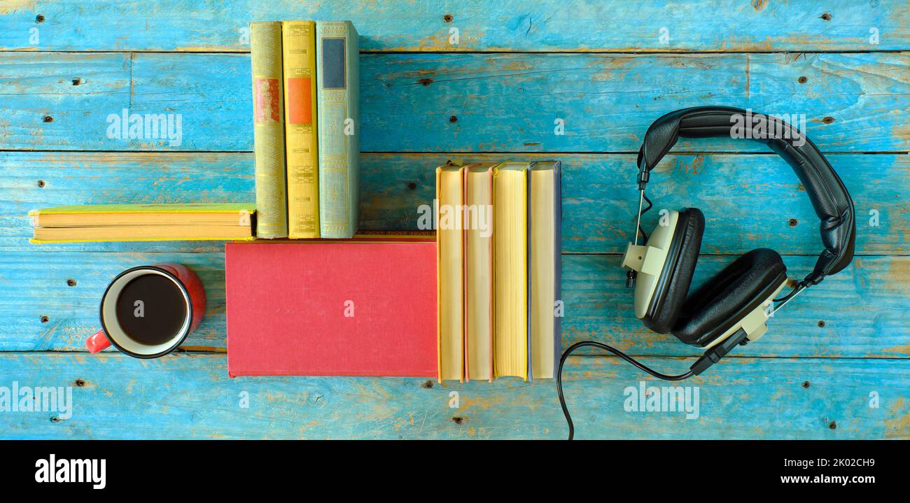 audio book concept with rows of books and vintage headphones,literature,entertainment,education, flat lay,good copy space Stock Photo