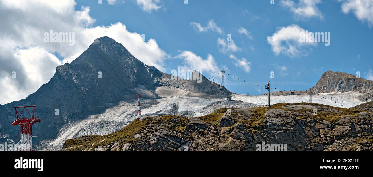view onto the mountain Kitzsteinhorn,  the remains of the glacier Schmiedingerkees and some gondola cableways at summer, Austria Stock Photo