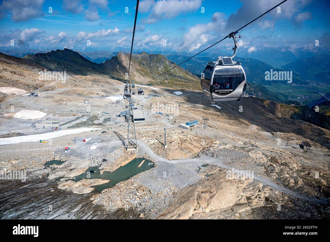 view onto the free of ice plateau on the mountain Kitzsteinhorn in summer and construction works for artificial snowmaking caused by glacier melting Stock Photo