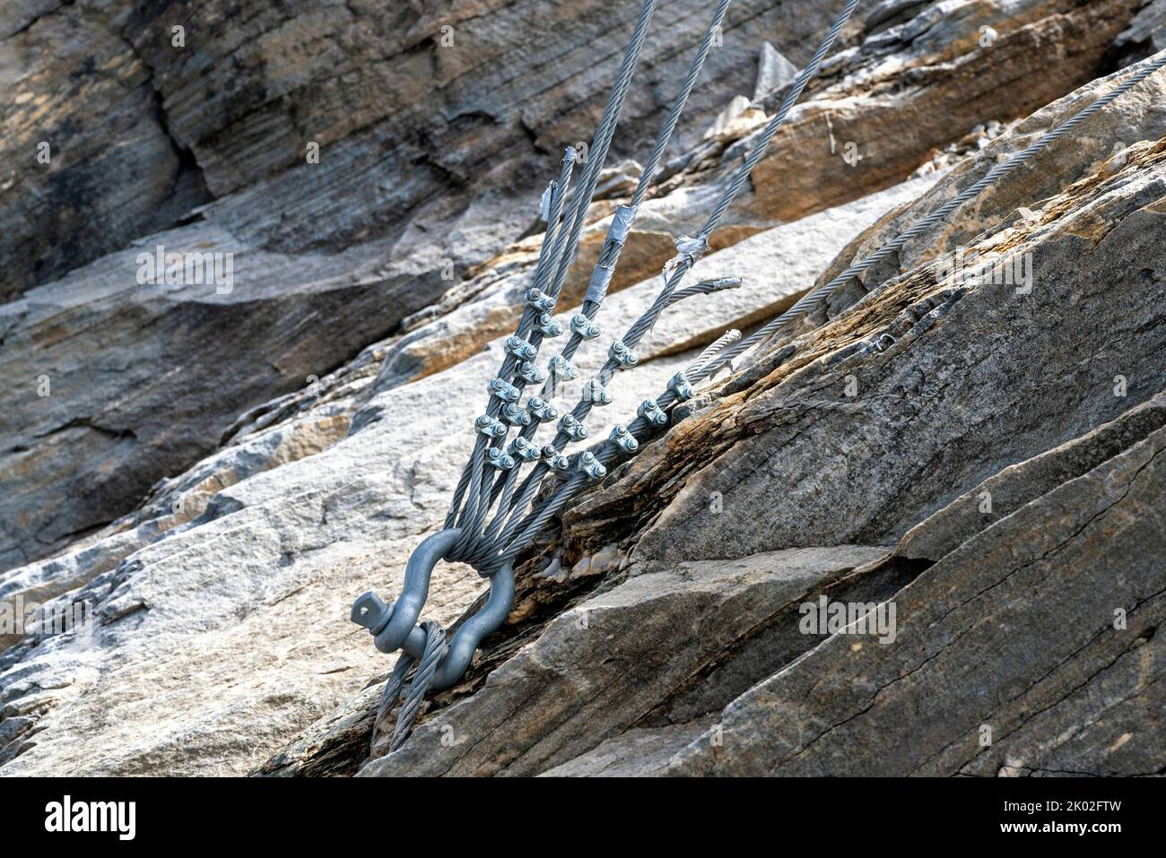 attachment of steel ropes with clamping on massive rock Stock Photo - Alamy
