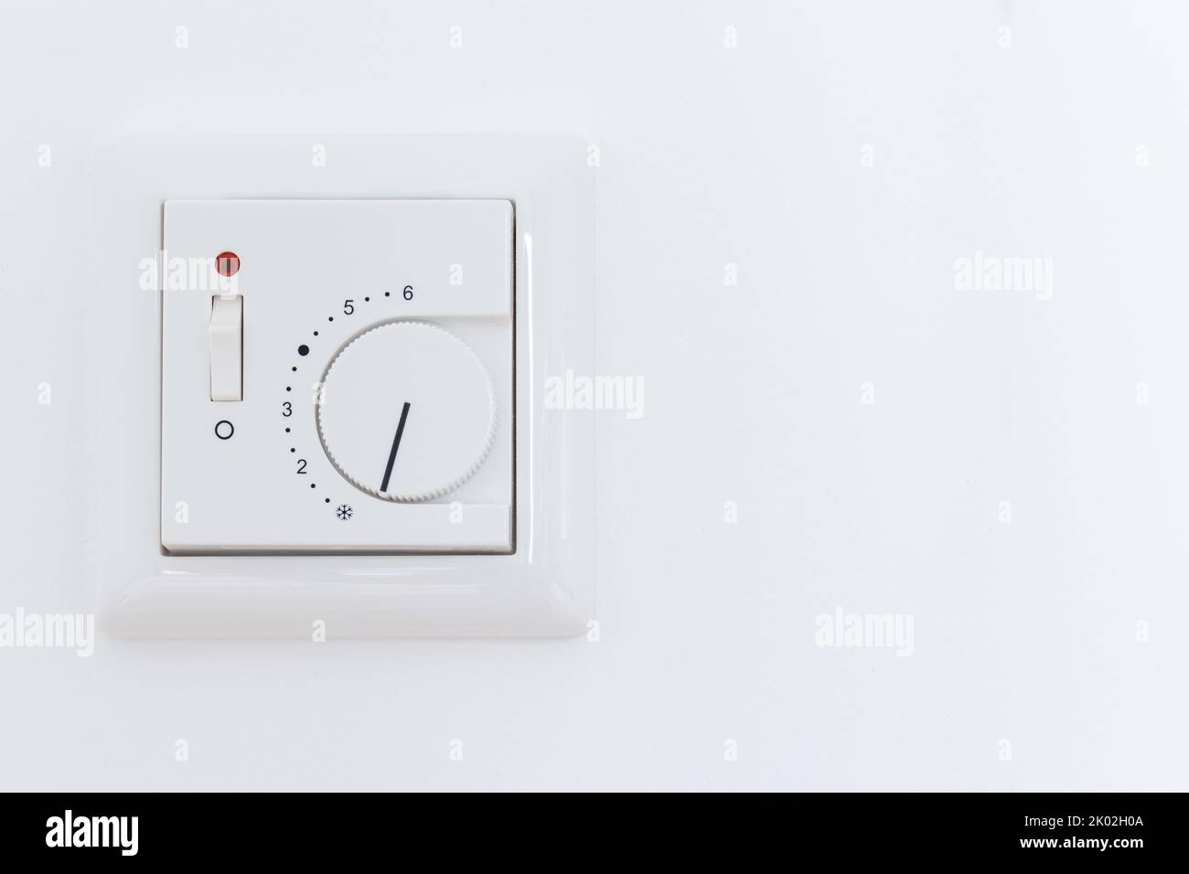 Thermostat heating switch on wall Stock Photo