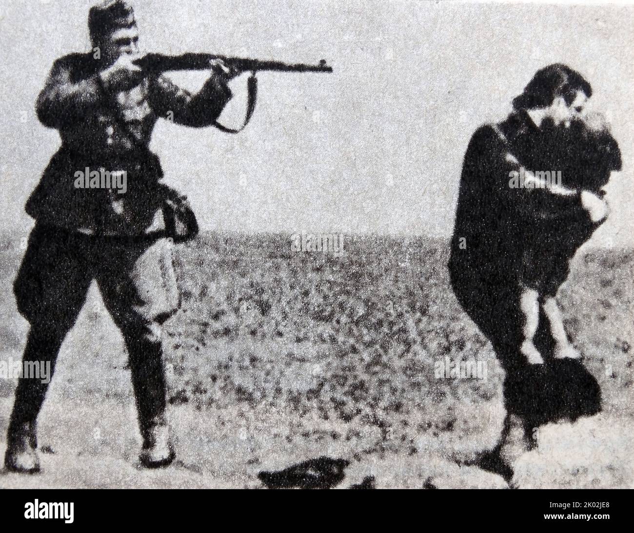 The Ivanhorod Einsatzgruppen photograph is an image of the Holocaust, showing a soldier aiming a rifle at a woman who is trying to shield a child with her body. It depicts the murder of Jews by an Einsatzgruppen death squad near Ivanhorod, Ukraine, in 1942. Stock Photo