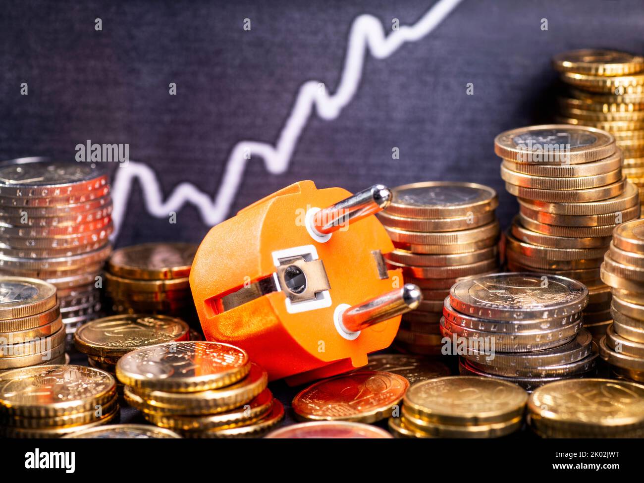 Rising electricity costs, plugs with stacks of money and graph with rising curve. Stock Photo