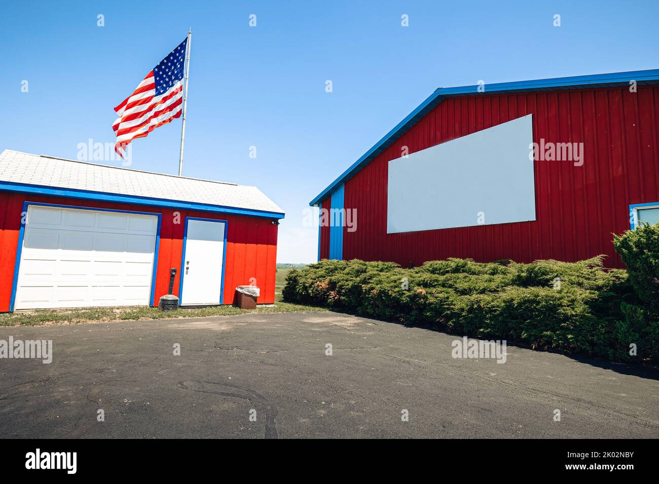 An automatic controlled poultry shed with waving American flag on the blue sky Stock Photo