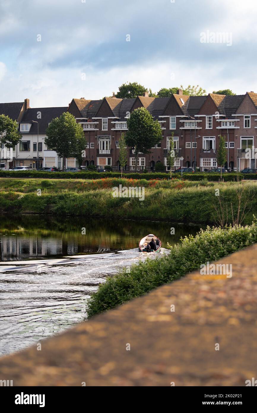 A vertical shot from the lakeshore of rows of buildings in 's-Hertogenbosch city, Netherlands Stock Photo