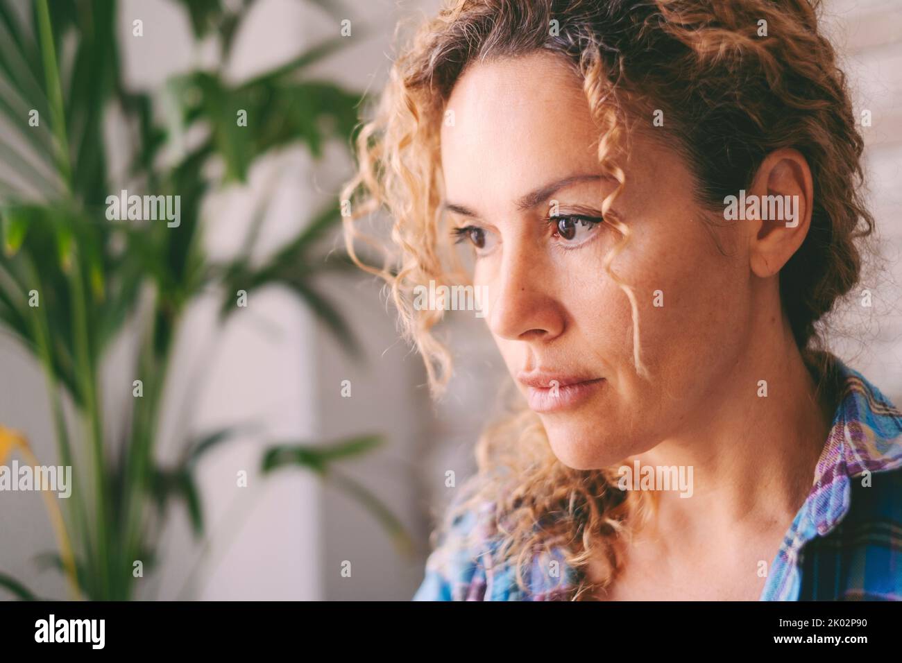 Serious and anxious portrait of adult middle age young woman at home indoor. Concept of worried female people and problems in life. Stress and depression loneliness illness disease healthy concept Stock Photo