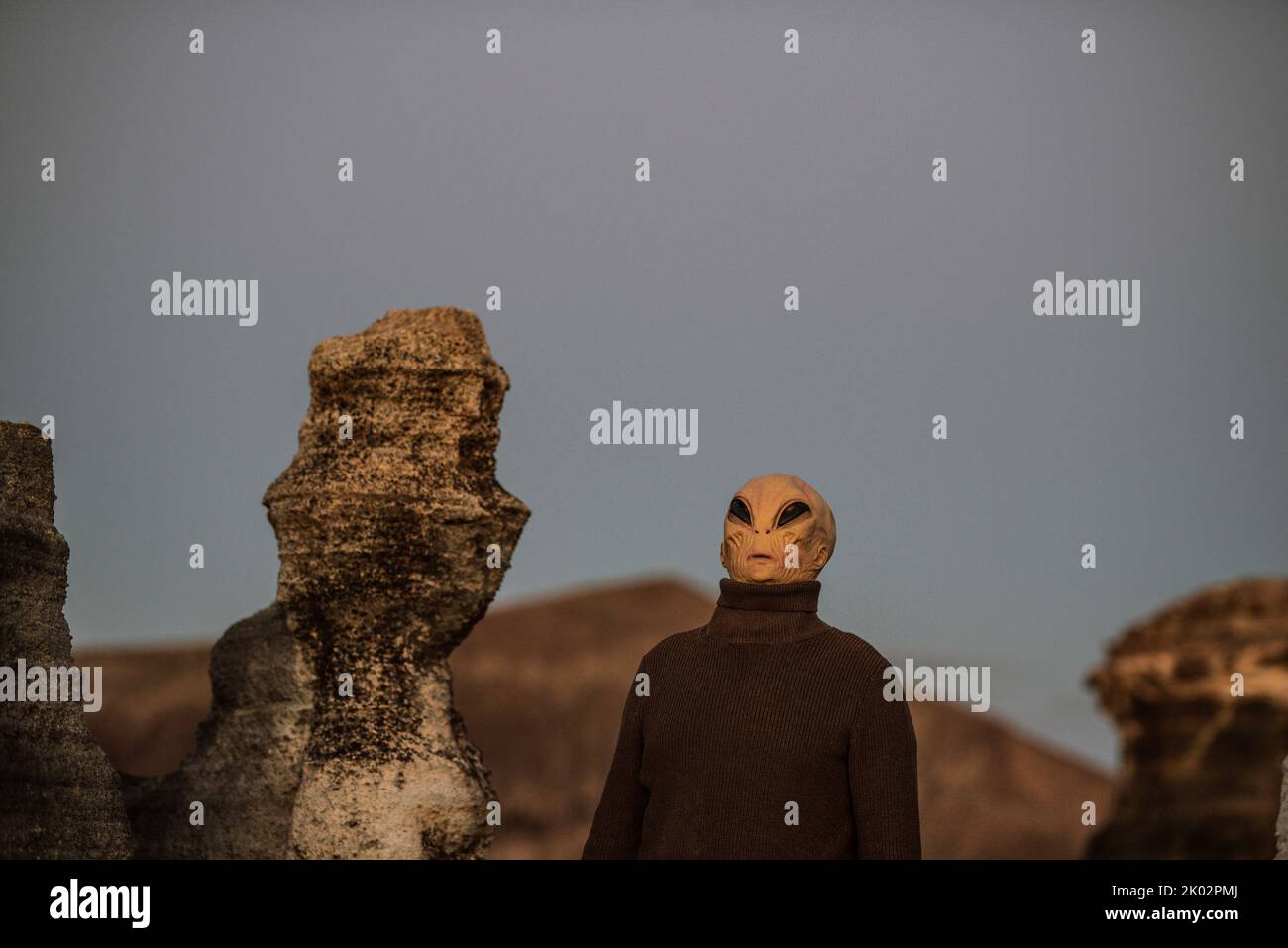 Alien ufo portrait with moon landscape in background. Standing extraterrestrial people on planet earth in outdoor scenic place. Concept of invasion or diversity. Mankind and humans Stock Photo