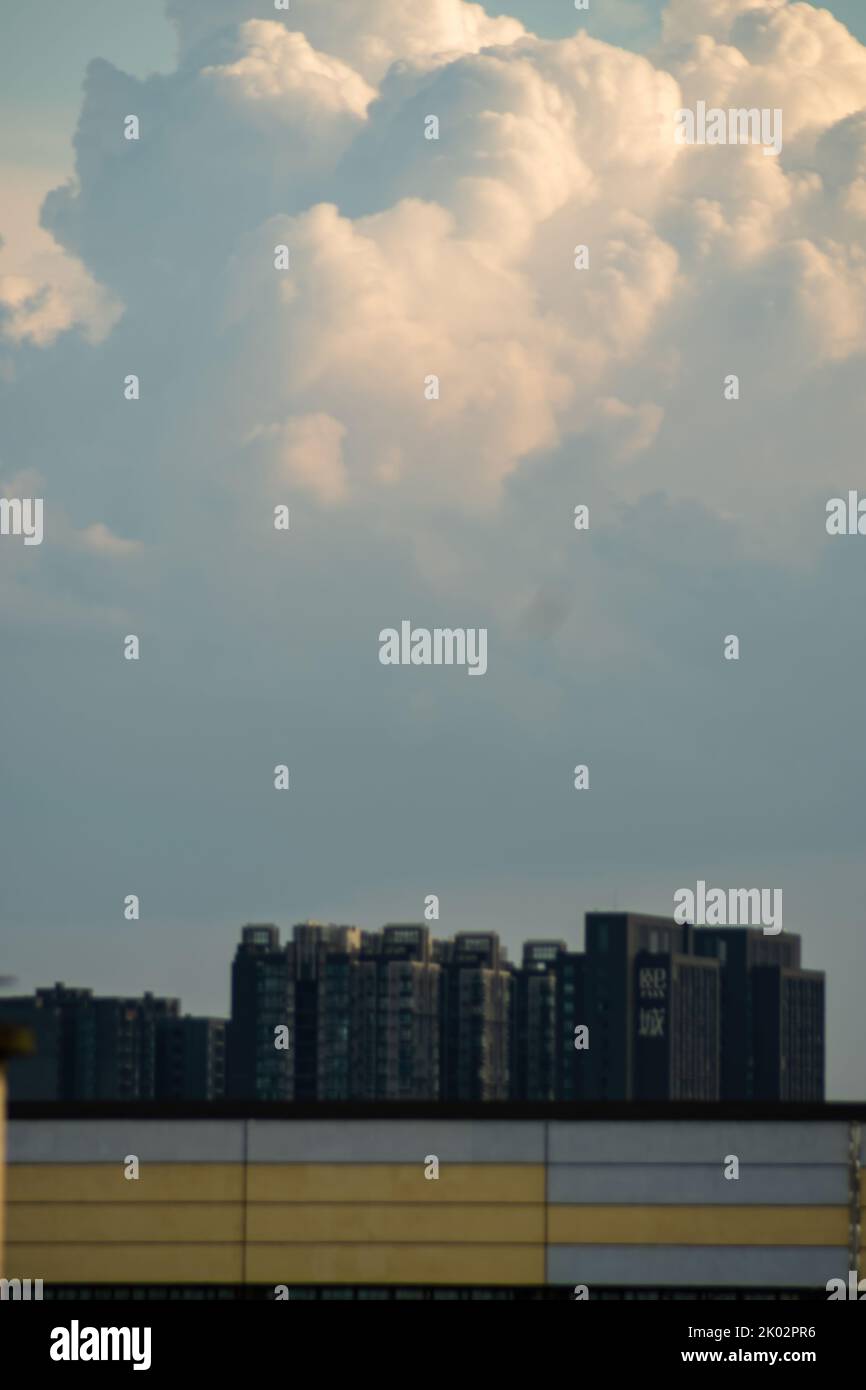 A vertical shot of buildings under a cloudy sky Stock Photo - Alamy