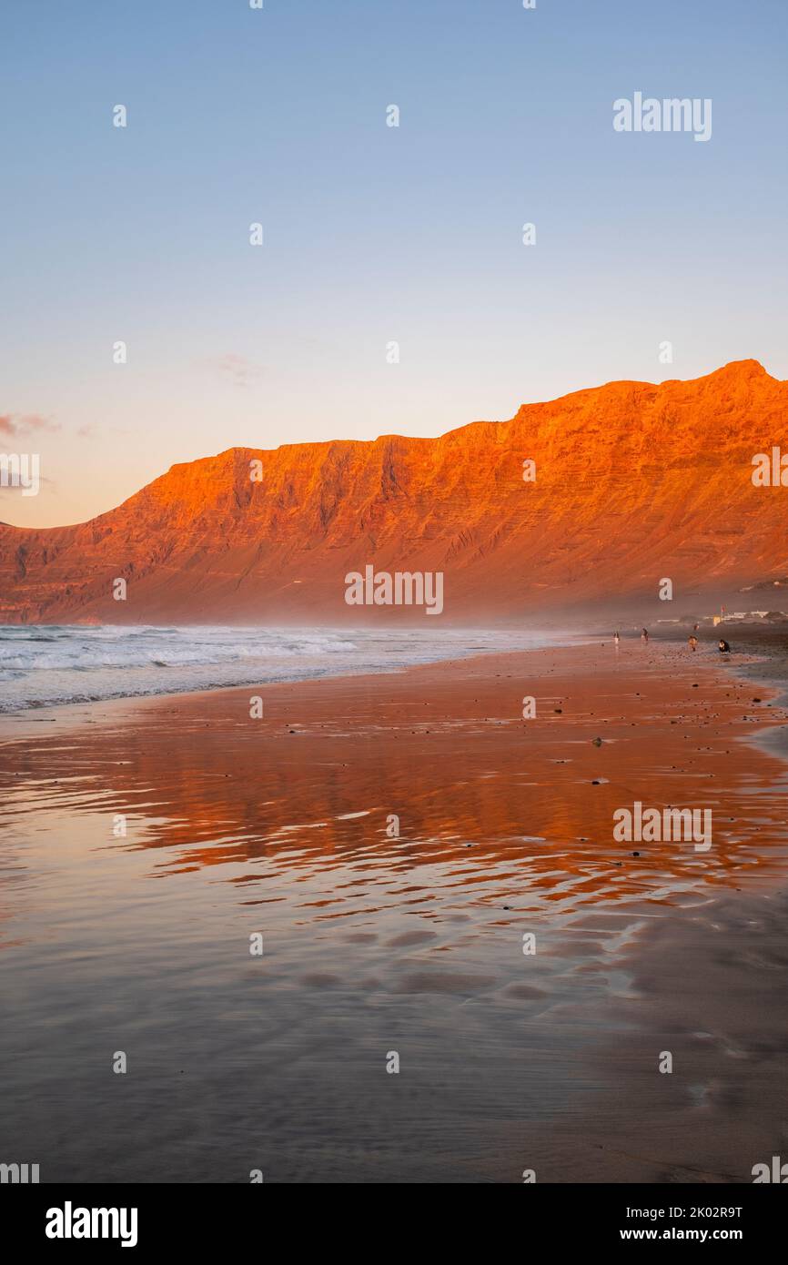 Beautiful landscape with sea shore reflection and red mountains on the coast. Concept of beach and summer holiday vacation travel destination. Nature outdoors ocean coastline Stock Photo