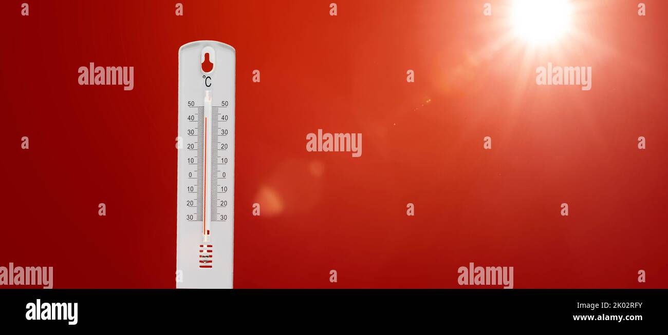 Thermometer with hot Celsius degrees against red background Stock Photo