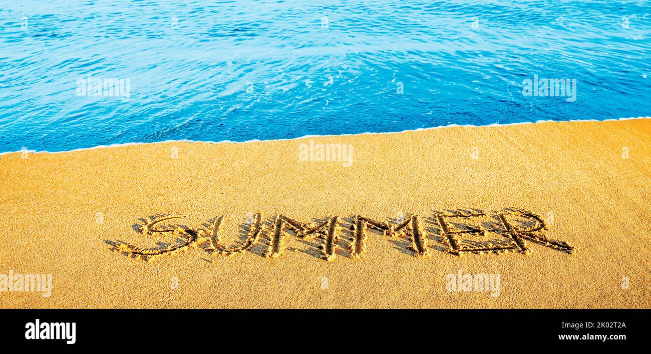 The word 'summer' written in the sand Stock Photo