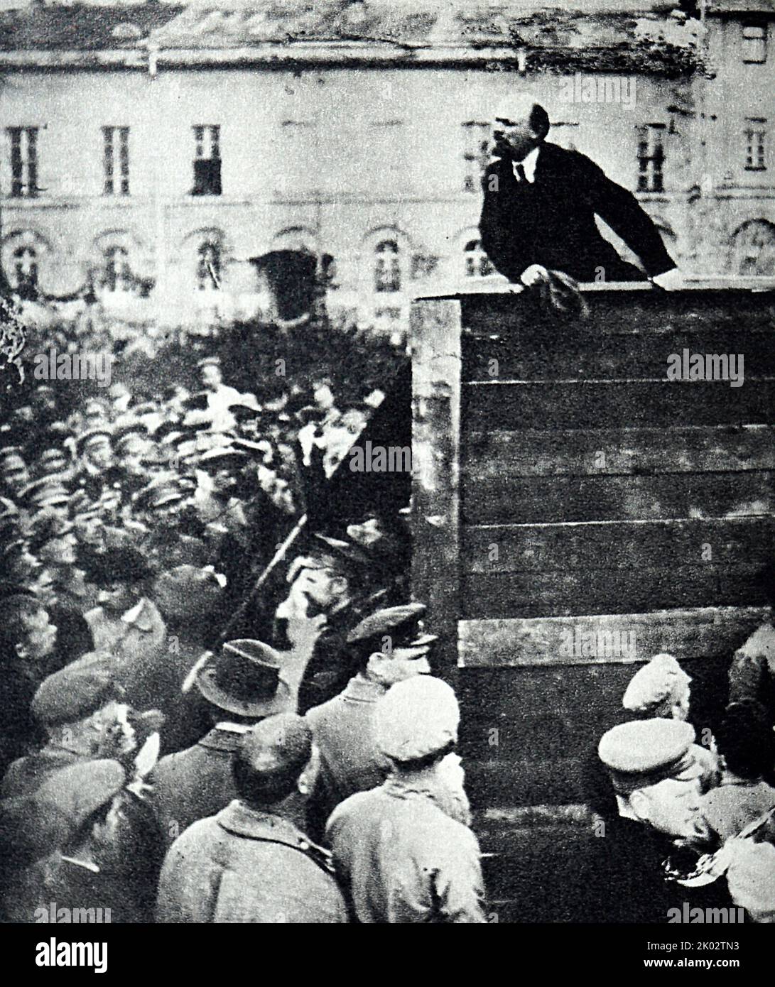 Vladimir Lenin delivers a speech on Sverdlov Square at the parade of troops leaving for the Polish front. Stock Photo